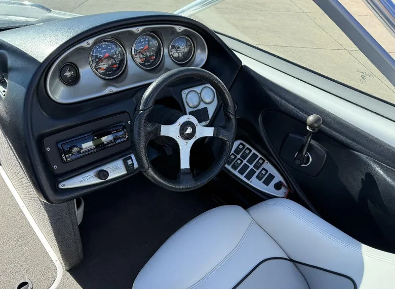 Slide: The Image of 2007 Centurion T5 boat dashboard with steering wheel, gauges, and control panel. - 12