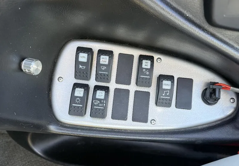 Slide: The Image of Control panel of a 2007 Centurion T5 boat with various switches and knobs. - 13