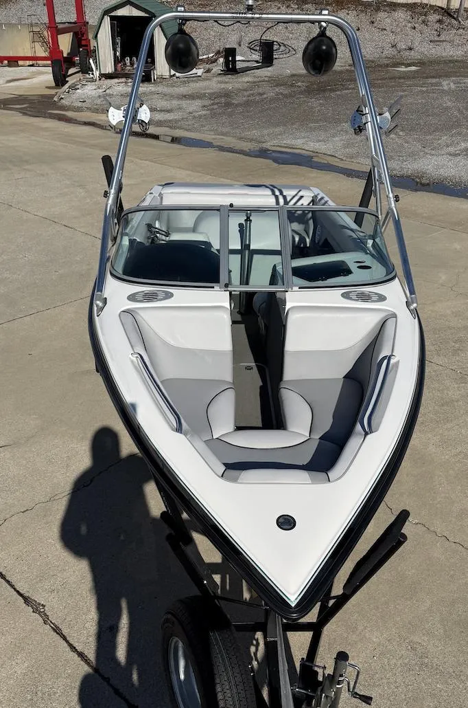 Slide: The Image of 2007 Centurion T5 boat on trailer, white and gray interior, parked on concrete. - 7