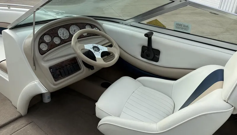 Slide: The Image of 2001 Caravelle 209 Bow Rider boat interior with steering wheel and dashboard. - 10