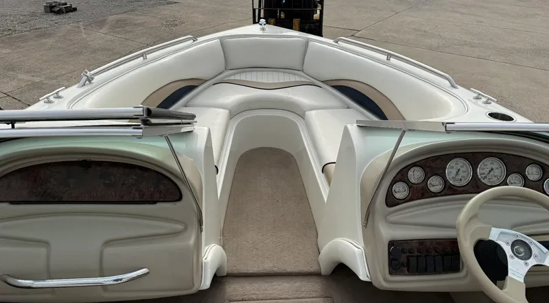 Slide: The Image of 2001 Caravelle 209 Bow Rider interior with white seating and dashboard controls. - 11