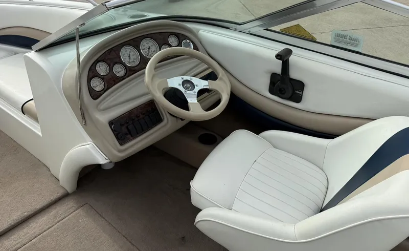 Slide: The Image of 2001 Caravelle 209 Bow Rider interior with steering wheel and dashboard controls. - 14