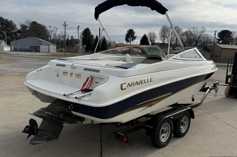 Slide: The Image of 2001 Caravelle 209 Bow Rider boat on trailer, parked outdoors. - 3
