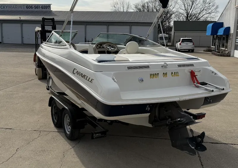 Slide: The Image of 2001 Caravelle 209 Bow Rider boat on trailer in a parking lot. - 4