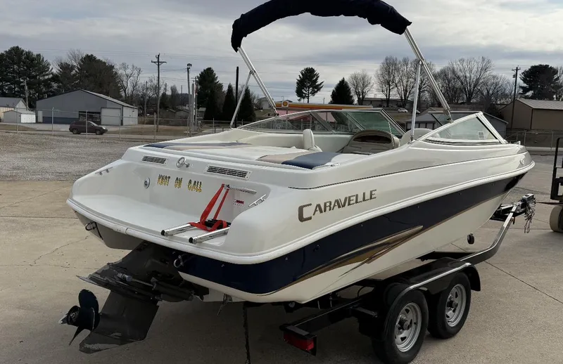 Slide: The Image of 2001 Caravelle 209 Bow Rider boat on trailer, parked outdoors. - 5
