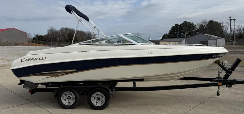 Slide: The Image of 2001 Caravelle 209 Bow Rider boat on trailer, parked outdoors. - 6