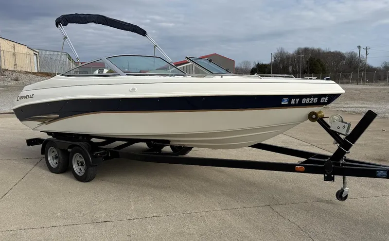 Slide: The Image of 2001 Caravelle 209 Bow Rider boat on trailer, parked outdoors. - 7