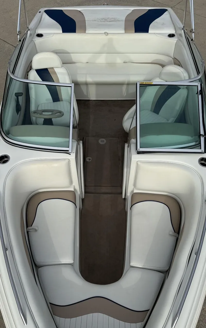 Slide: The Image of 2001 Caravelle 209 Bow Rider boat interior with white and beige seating. - 9
