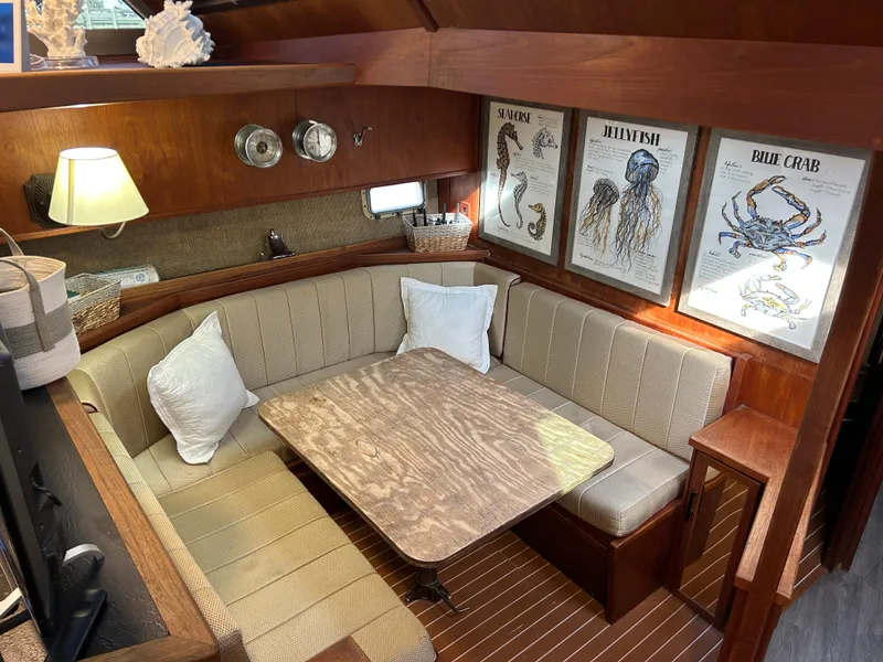 Slide: The Image of 1985 Viking 50 Cockpit MY interior with cozy dining area and marine-themed decor. - 14