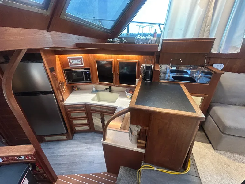 Slide: The Image of Interior of 1985 Viking 50 Cockpit MY yacht with modern kitchen amenities. - 15