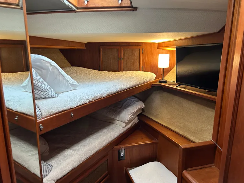 Slide: The Image of 1985 Viking 50 Cockpit MY cabin with cozy bunk beds and a TV. - 21