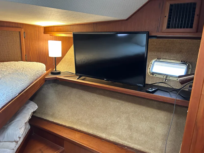 Slide: The Image of Cozy cabin interior of 1985 Viking 50 Cockpit MY with TV and lamp. - 22