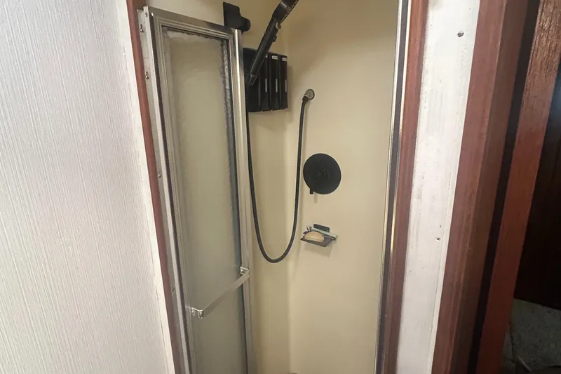 Slide: The Image of Shower area in 1985 Viking 50 Cockpit MY yacht with glass door and handheld showerhead. - 29