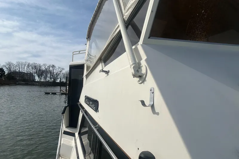 Slide: The Image of 1985 Viking 50 Cockpit MY yacht on calm water, side view. - 30