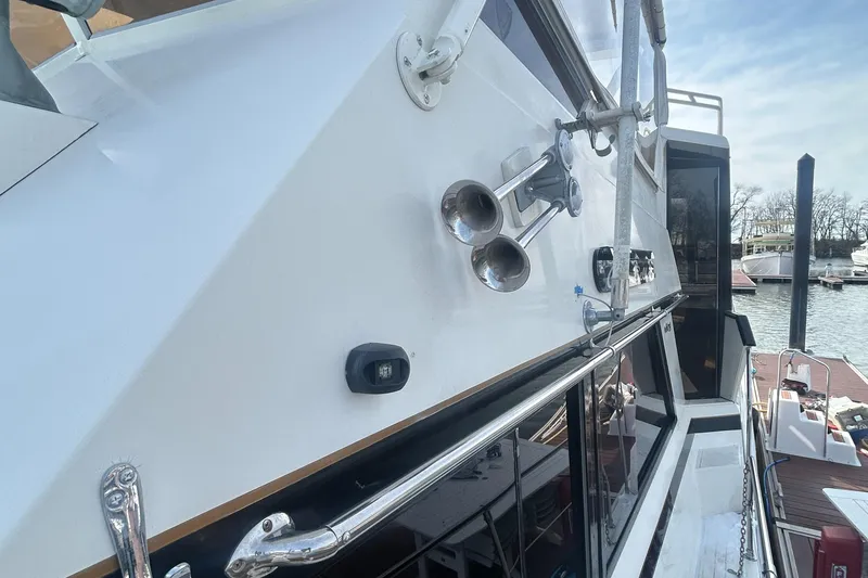 Slide: The Image of 1985 Viking 50 Cockpit MY yacht exterior with chrome details and docked at marina. - 34