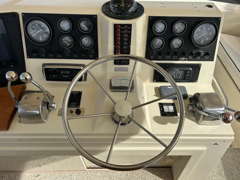 Slide: The Image of 1985 Viking 50 Cockpit MY helm with gauges, steering wheel, and controls. - 36