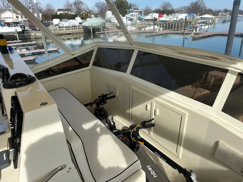 Slide: The Image of 1985 Viking 50 Cockpit MY interior with seating and marina view. - 38