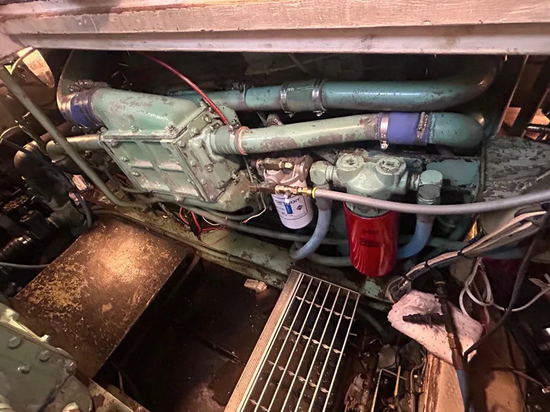 Slide: The Image of Engine compartment of a 1985 Viking 50 Cockpit MY yacht, showcasing mechanical components. - 42