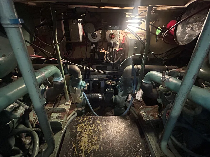 Slide: The Image of Engine room of 1985 Viking 50 Cockpit MY with visible machinery and wiring. - 43