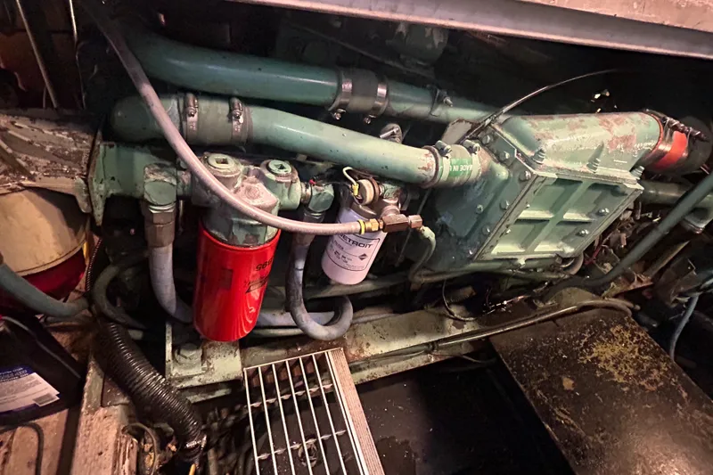 Slide: The Image of Engine compartment of a 1985 Viking 50 Cockpit MY boat, showing mechanical components. - 44