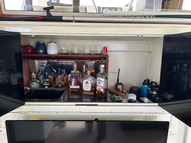 Slide: The Image of Bar area on a 1985 Viking 50 Cockpit MY yacht with assorted liquor bottles and glasses. - 5