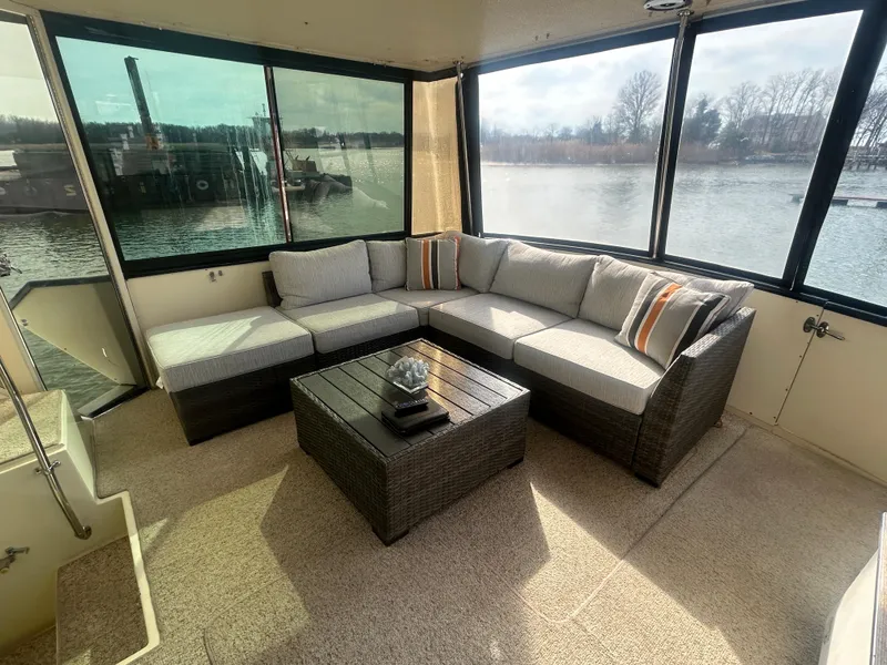 Slide: The Image of 1985 Viking 50 Cockpit MY interior with cozy seating and waterfront view. - 6