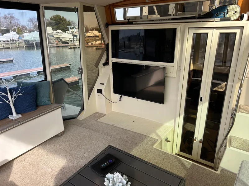 Slide: The Image of Interior of 1985 Viking 50 Cockpit MY yacht with TV and waterfront view. - 8