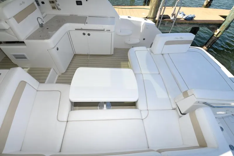 Slide: The Image of 2010 Sea Ray 450 Sundancer yacht interior with white seating and table. - 10