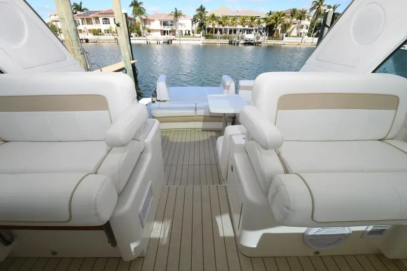 Slide: The Image of Luxurious interior of 2010 Sea Ray 450 Sundancer yacht with white seating and waterfront view. - 14