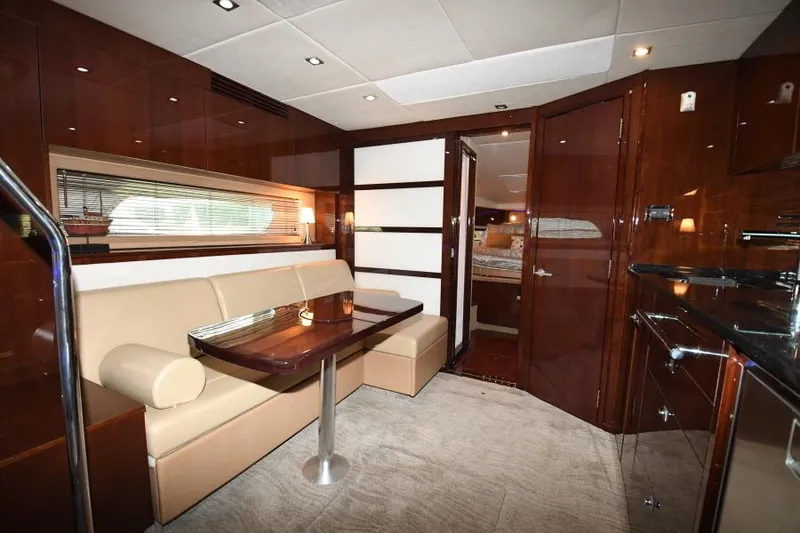 Slide: The Image of Luxurious interior of 2010 Sea Ray 450 Sundancer yacht with elegant seating and wood finishes. - 19
