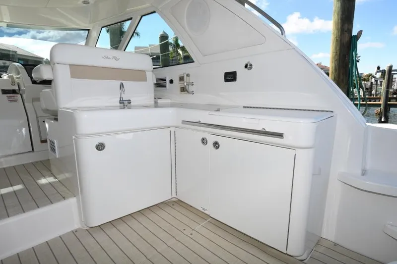 Slide: The Image of 2010 Sea Ray 450 Sundancer yacht interior with sleek white cabinetry and modern design. - 21