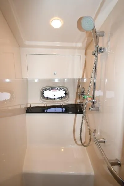 Slide: The Image of 2010 Sea Ray 450 Sundancer bathroom with shower and porthole window. - 22