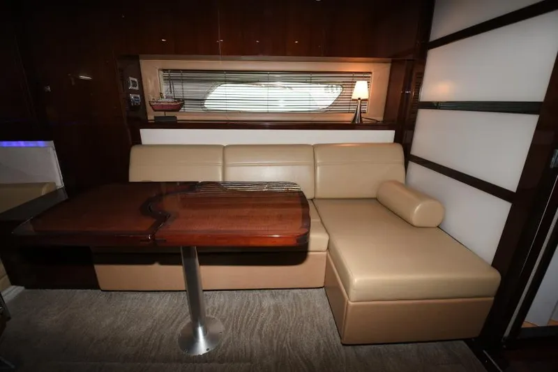 Slide: The Image of Interior of 2010 Sea Ray 450 Sundancer with beige leather seating and wooden table. - 29
