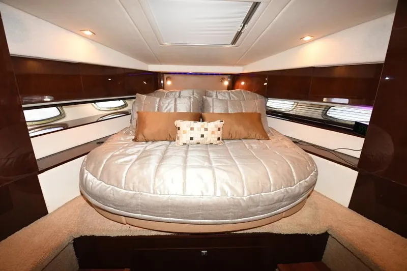 Slide: The Image of Luxurious bedroom interior of 2010 Sea Ray 450 Sundancer yacht with plush bedding. - 30