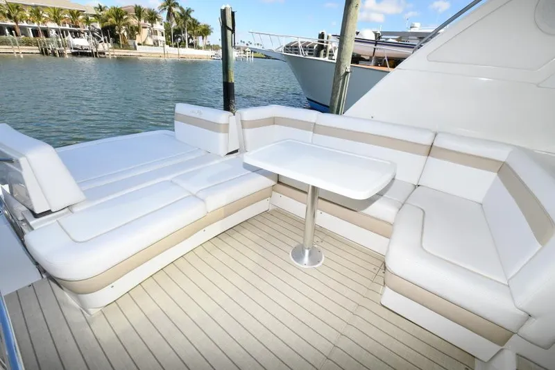 Slide: The Image of 2010 Sea Ray 450 Sundancer yacht with white seating and table on deck. - 32