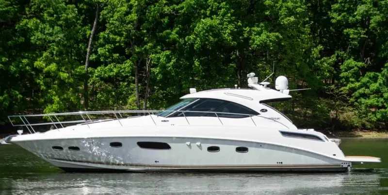 The Image of 2010 Sea Ray 470 Sundancer yacht cruising on a serene lake. - 0