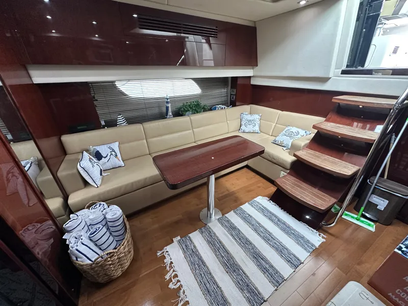 Slide: The Image of Luxurious interior of 2010 Sea Ray 470 Sundancer yacht with beige seating and wooden accents. - 20