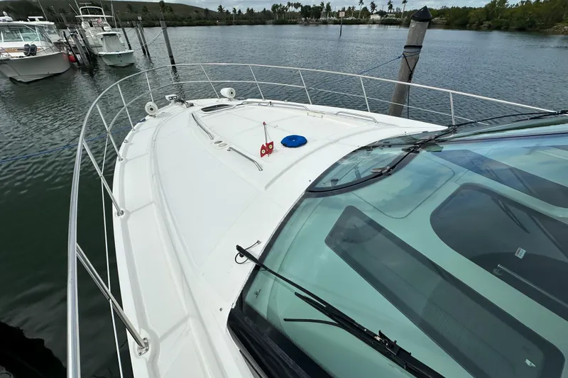 Slide: The Image of 2010 Sea Ray 470 Sundancer yacht docked on calm water. - 25