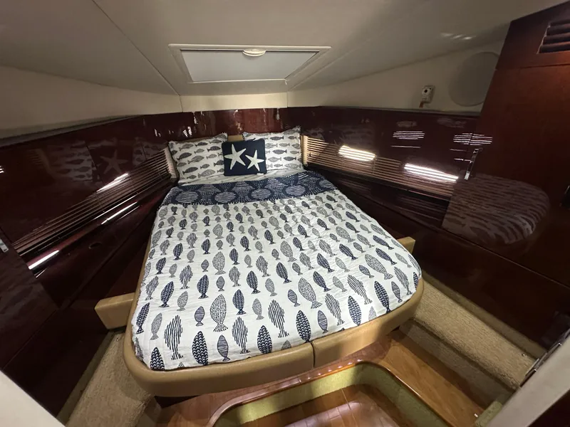 Slide: The Image of Luxurious cabin interior of 2010 Sea Ray 470 Sundancer with nautical-themed bedding. - 26