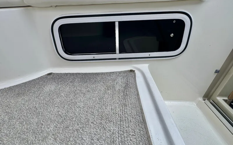 Slide: The Image of Interior of 2005 Sea Ray Sundancer 260 with carpeted flooring. - 19