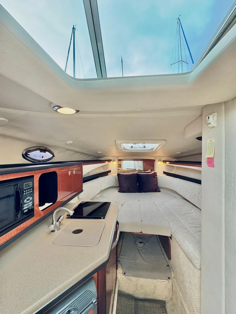Slide: The Image of Interior of a 2005 Sea Ray Sundancer 260 yacht with kitchenette and sleeping area. - 24