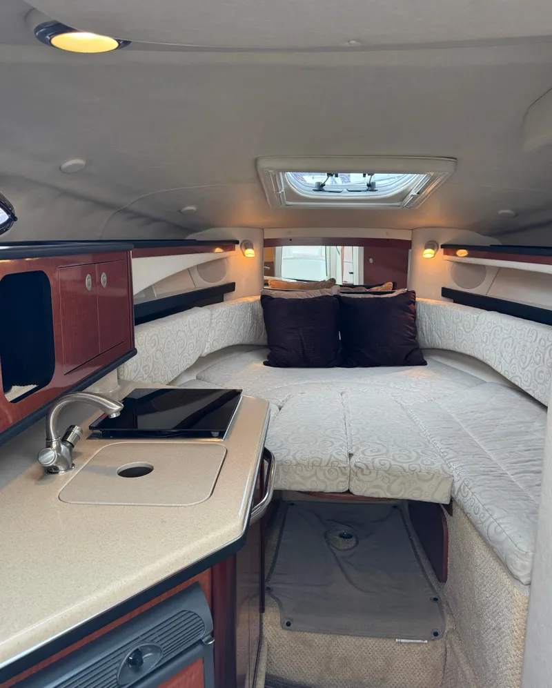 Slide: The Image of Interior of a 2005 Sea Ray Sundancer 260 with cozy bed and kitchenette. - 25