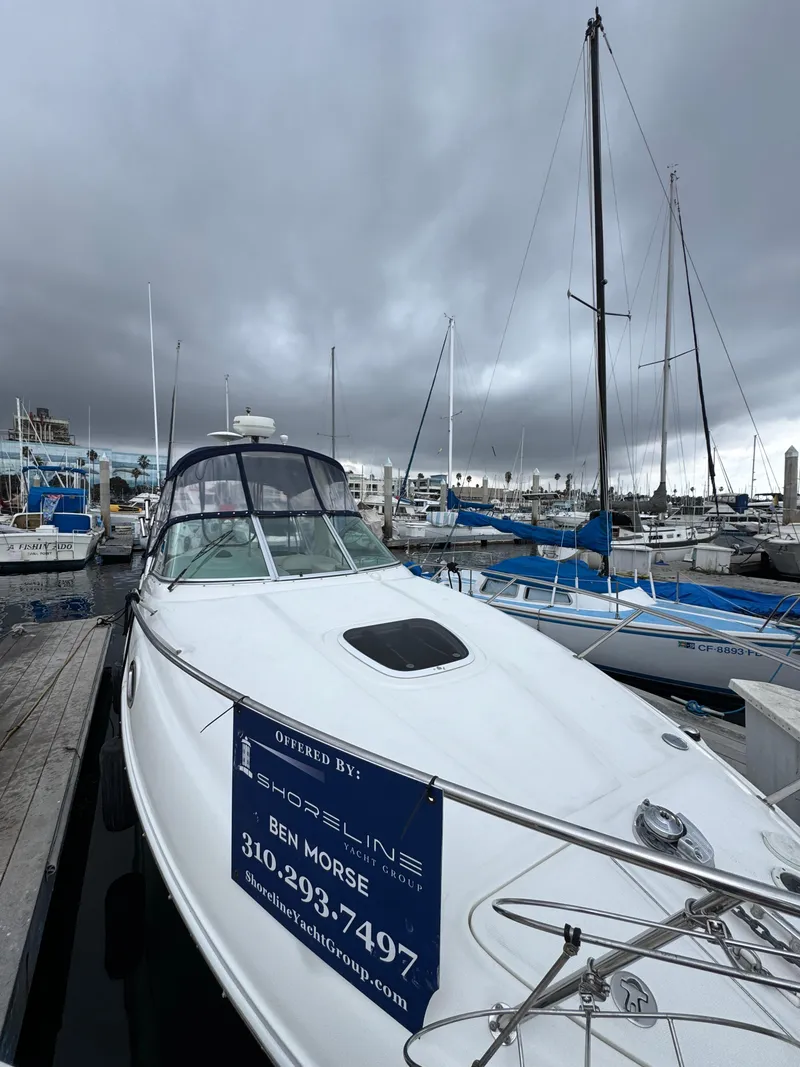 Slide: The Image of 2005 Sea Ray Sundancer 260 docked under cloudy skies. - 42