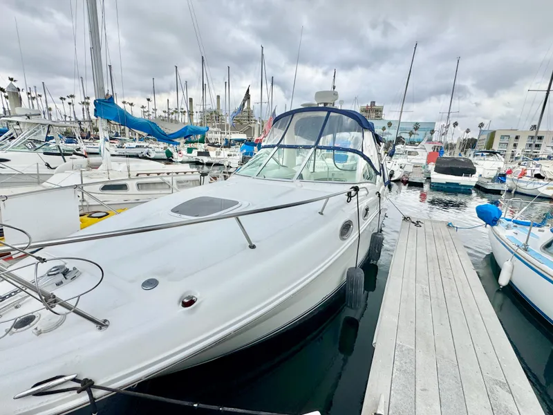 Slide: The Image of 2005 Sea Ray Sundancer 260 docked in marina, cloudy sky. - 5