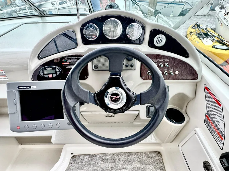 Slide: The Image of 2005 Sea Ray Sundancer 260 helm with steering wheel and controls. - 6