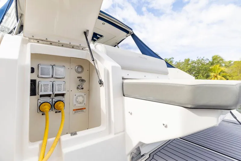 Slide: The Image of 2020 Sea Ray Sundancer 320 electrical panel with yellow cables, outdoor setting. - 11