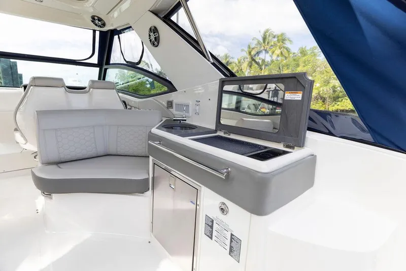 Slide: The Image of 2020 Sea Ray Sundancer 320 interior with seating and kitchenette, featuring modern design elements. - 12