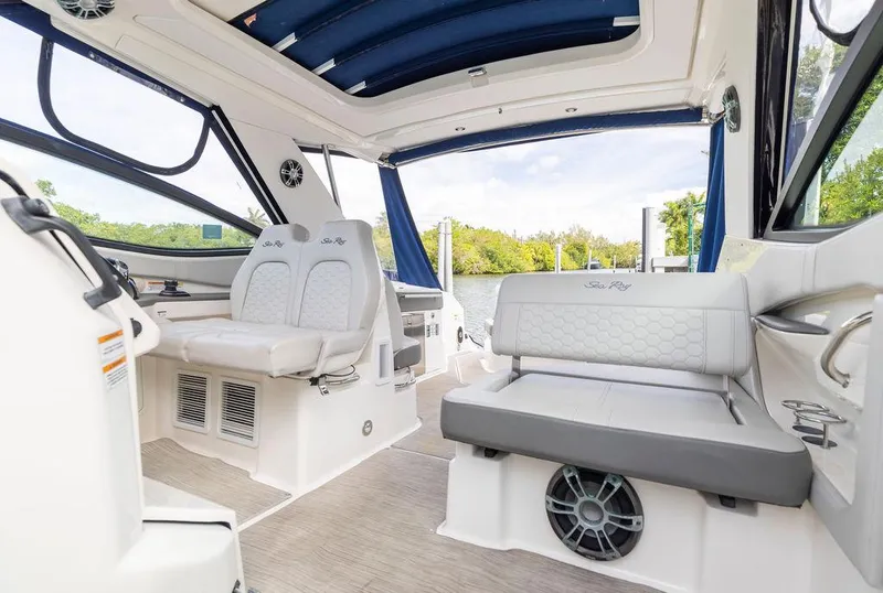 Slide: The Image of 2020 Sea Ray Sundancer 320 interior with plush seating and scenic water view. - 19