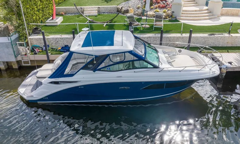 Slide: The Image of 2020 Sea Ray Sundancer 320 docked, featuring sleek design and modern amenities. - 2