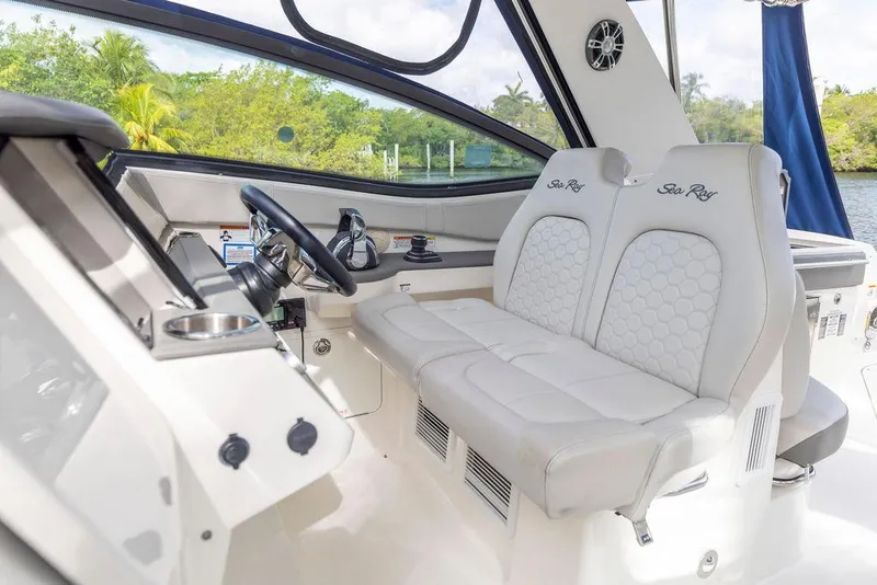 Slide: The Image of 2020 Sea Ray Sundancer 320 helm with plush seating and modern controls. - 20